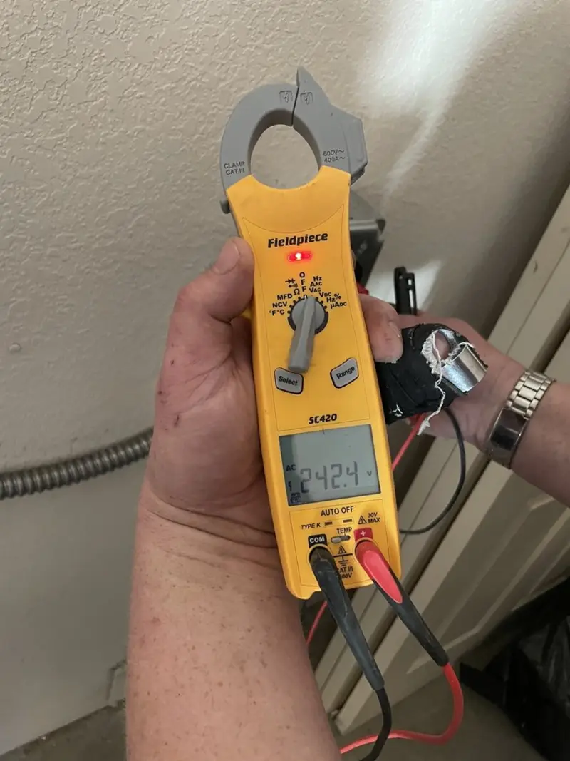 Voltage testing with clamp meter during Outlet Installation in Canaan